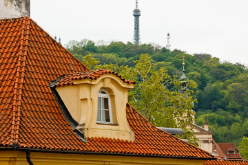 Prague. 05.10.2019: Low light detail of patina red roof top. Prague Lesser Town typical roofing material. Old roofing of clay tiles. Various orange shades and stains.