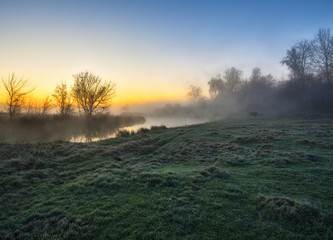 autumn river. misty sunrise in a river valley