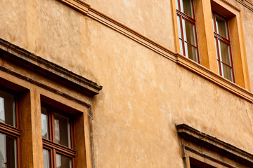 Obraz premium Prague, Czech Republic. 10.05.2019: Close-up view of the facade with windows of old historical buildings in Prague. Photo of abandoned buildings in the city center. Retro, old-fashioned, vintage, .