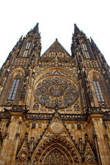 Fototapeta na wymiar Prague. 05.10.2019: Perspective view of the Metropolitan Cathedral of Saints Vitus, Wenceslaus and Adalbert, an excellent example of Gothic architecture. Golden Gate South Tower with clock.