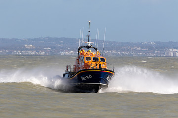Fototapeta premium Eastbourne, UK. February 11th 2020: Eastbourne RNLI Lifeboat rises out of the water.