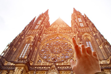 Prague. 05.10.2019: Perspective view of the Metropolitan Cathedral of Saints Vitus, Wenceslaus and Adalbert, an excellent example of Gothic architecture. Golden Gate South Tower with clock.