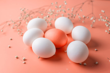 Bright red Easter egg among white ones on a pastel background. Festive spring card