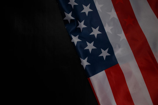 Close up of waving national usa american flag on black background with copy space.