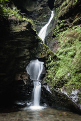 waterfall with hole in forest