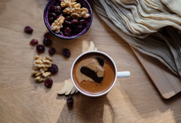 turkish coffee with dry berreis and walnut on wood table