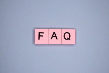 FAQ word wooden cubes on blue background