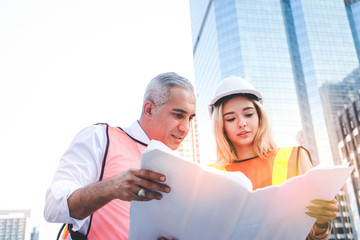 Civil engineers and young architects, multi-ethnic building designers working together on a...