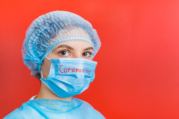 Portrait of a woman wearing medical uniform and mask with coronavirus word at red background. Coronavirus concept. Respiratory protection concept with copy space