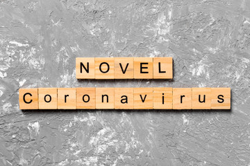 Novel coronavirus word written on wood block. text on wooden table for your desing, Wuhan...