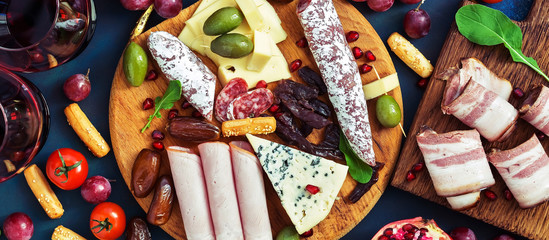 Italian antipasti wine snacks set, prosciutto,cheese, olives, grapes, sausage and cold meat. Top...
