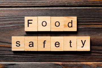food safety word written on wood block. food safety text on table, concept