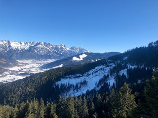 Winter mountains with fresh snow and blue sky in Saalbach-Hinterglemm, Austria