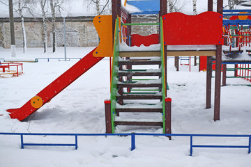 Colorful playground after winter snow.