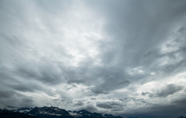 Naklejka premium Blue, scattered, dark. stormy clouds during the day