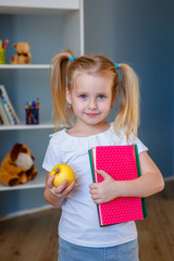 the concept to school of education. A little girl with a book  in her hands