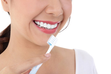 Beautiful smiling woman, clean white teeth, pink lips, hold a toothbrush. Oral care concept. White...