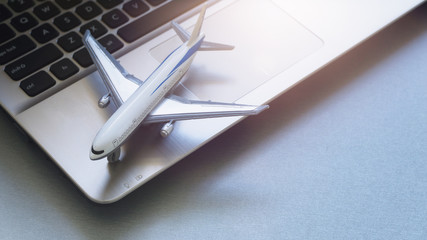 top view of airplane model on laptop online flight schedule concept booking travel agency ticket