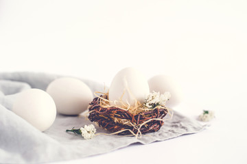 Light Easter background with white Easter eggs.