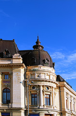 Fototapeta na wymiar Ancient facade of the Central University Library against blue sky. It founded in 1895 as the Carol I Library of the University Foundation. Notable landmark of Bucharest, Romania
