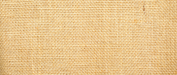 Hessian sackcloth burlap woven texture background  / cotton woven fabric background with flecks of varying colors of beige and brown. with copy space. office desk concept.