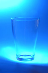 one glass on blue background