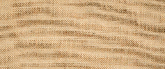 Hessian sackcloth burlap woven texture background  / cotton woven fabric background with flecks of varying colors of beige and brown. with copy space. office desk concept.