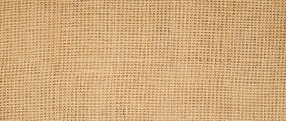 Hessian sackcloth burlap woven texture background  / cotton woven fabric background with flecks of varying colors of beige and brown. with copy space. office desk concept.