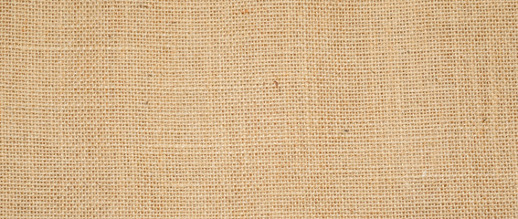 Hessian sackcloth burlap woven texture background  / cotton woven fabric background with flecks of varying colors of beige and brown. with copy space. office desk concept.