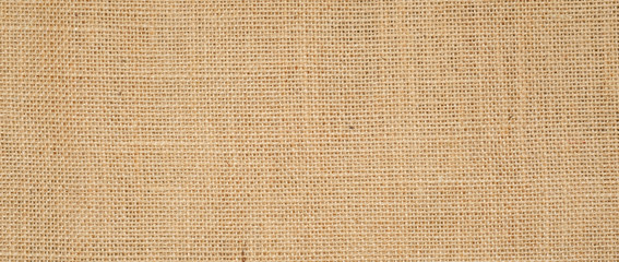 Hessian sackcloth burlap woven texture background  / cotton woven fabric background with flecks of varying colors of beige and brown. with copy space. office desk concept.