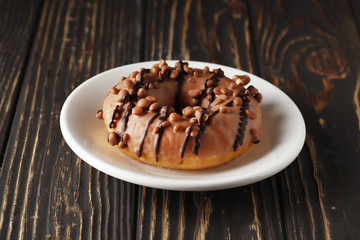 Sweet donuts on a wooden background. Place for text