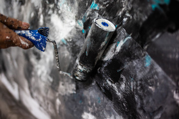 Decorator's hand painting wall with roller