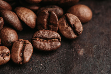 Coffee beans on the rustic wooden background. Selective focus. Shallow depth of field.