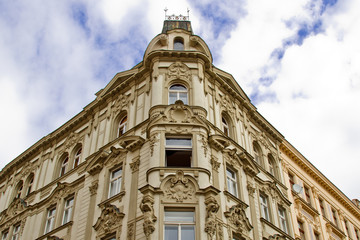 Fototapeta na wymiar Prague, Czech Republic. 10.05.2019: Close-up view of the facade with windows of old historical buildings in Prague. Retro, old-fashioned, vintage, last century.