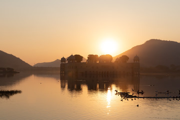 Jal Mahal Palace in the Man Sagar Lake, sunrise silhouette, Jaipur, India
