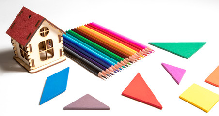 set of colored pencils and geometric shapes on white