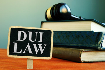 DUI law driving under the influence sign and books.