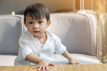 Fototapeta premium A boy wearing a white shirt And wearing black caps, are interested in something And looking at something