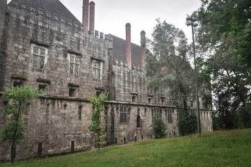 Medieval stone castle with towers. A view from the trees. Europe, Guimaraes, Portugal	