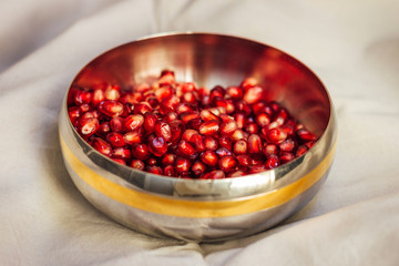 Pomegranate seeds in an iron plate