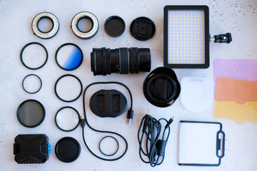 Flat lay composition with equipment for professional photographer on grey background.