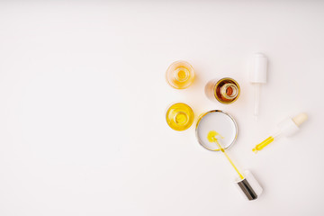 Pipette droppers and opened bottles with moisturizing cosmetic oil isolated on a white background. Top view
