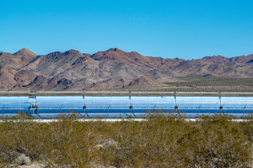This concentrated solar power plant uses a trough of parabolic mirrors to focus thermal energy on a water-filled receiver tube to generate steam.