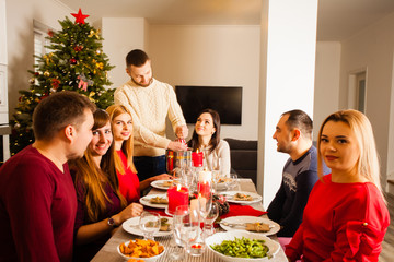 relatives celebrating at he table during christmas eve