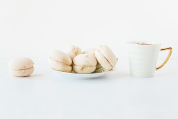 Homemade marshmallows and tea cup.White background.Minimalism.Copy space