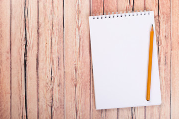 blank notebook with pen on a wooden table, business concept concept of a new workplace