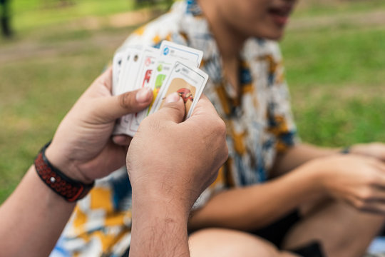The image of people sitting and playing card