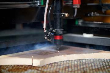Burning machine and wooden board in workshop