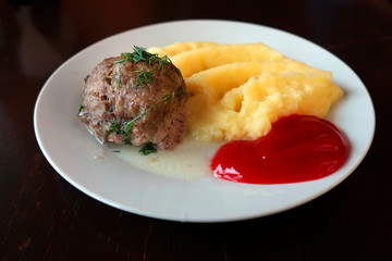 cutlet with mashed potatoes and tomato ketchup on a plate