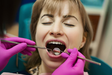 the client at the dentist s appointment in the office smiles, teeth whitening at the dentist, medicine concept